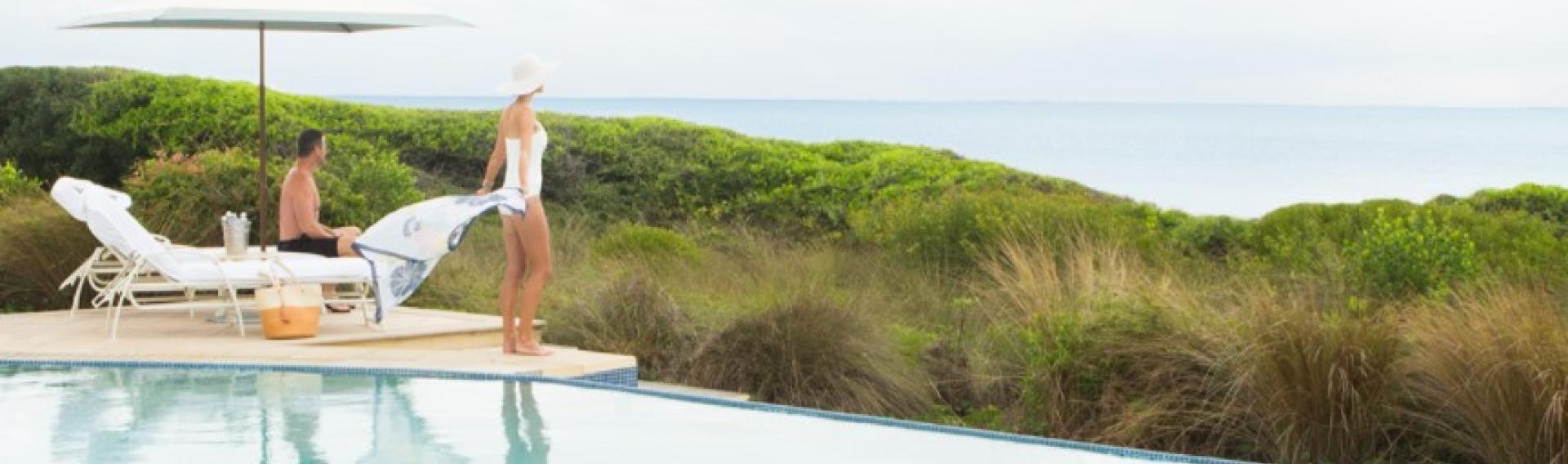 View of two people at the pool over looking the ocean, Kiawah Island South Carolina CME CLE CE destination.